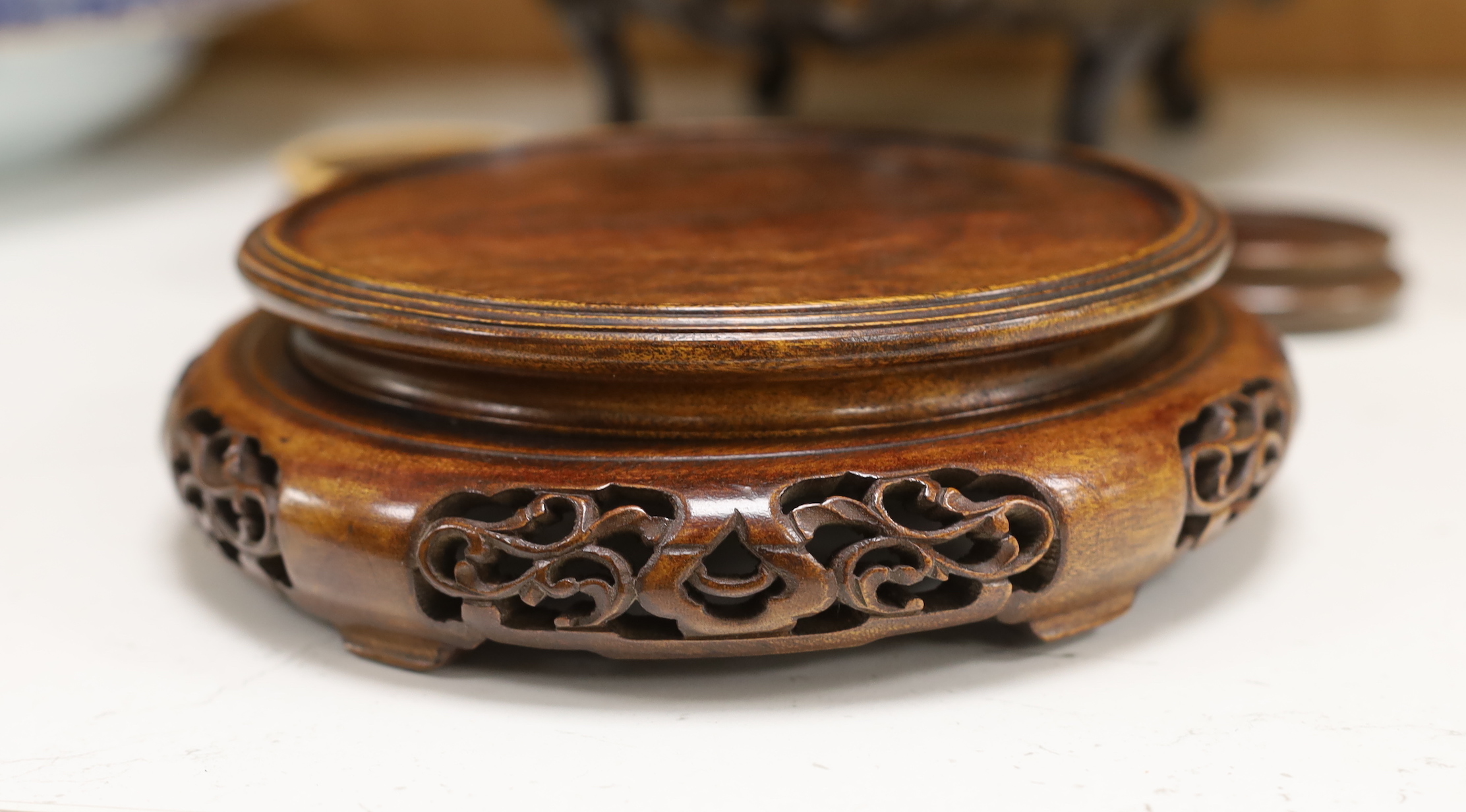 Two large Chinese or Japanese hardwood stands and four others, largest 11cm high